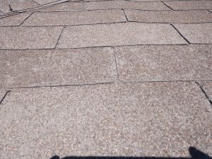 Inspecting storm damage on a roof in the metro Temple-Killeen area of Texas