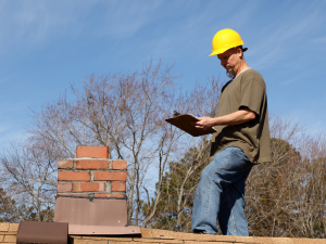 Roofer in Rockdale assisting a homeowner with insurance paperwork and damage assessment.