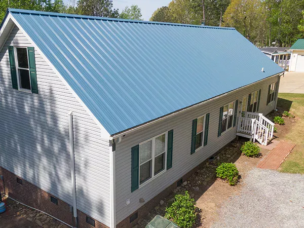 Small home with a blue metal roof