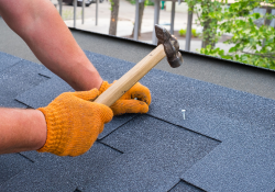 Temple Killeen roofer hand nailing shingles for superior quality roofing services.